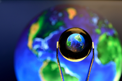 Closeup of a Little Glass ball reflecting the planet earth / GutoSantos Closeup of a Little Glass ball reflecting and inverting the planet earth